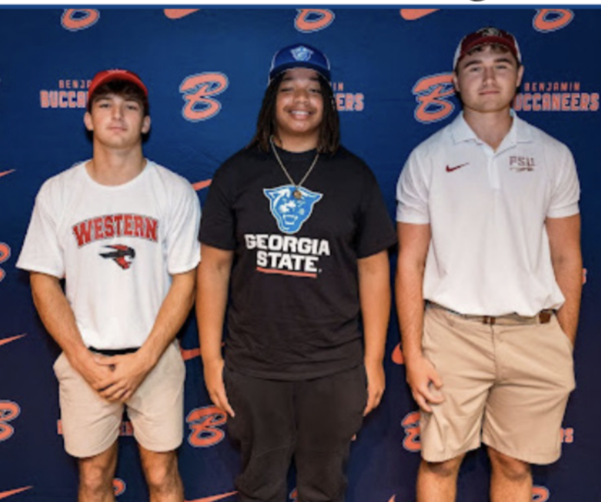 From left to right: Robert Letsche, D’Andre LaVassaur, and Jackson Hamilton all
pose for a photo after signing their National Letter of Intent on April 26. 